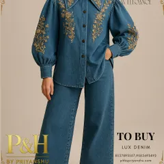 A detailed view of the blue denim shirt, focusing on the intricate gold embroidery on the collar and puff sleeves, highlighting the handcrafted artistry.