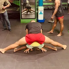 Helping one of my littlest students with a flexibility drill. Building a strong and flexible body starts young, and we do it with care and expert guidance.