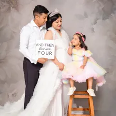 Welcoming a new baby is a family affair. This heartwarming family maternity session features the older sister-to-be, celebrating the moment their family of three becomes four. We have fun props like this sign to make the announcement special.