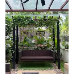 A garden swing at Chaithanya Samarpan, enveloped by climbing plants on a custom pergola. This creates a perfect, shaded nook for quiet contemplation, demonstrating how landscape elements can be designed for specific, personal experiences.