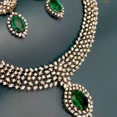 For those who embrace elegance at every turn, this prong set diamond and emerald necklace radiates sophistication and charm. It is the perfect accessory for moments that call for understated luxury.