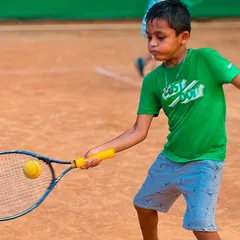 Perfect focus from a young player. This is a great example of a beginner connecting with the ball on a forehand shot, keeping his eye on the target. Badiya!