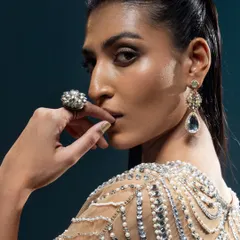 A close-up on a stunning piece of modern jewellery. The intricate design and beading of this shoulder and back accessory adds a unique, high-fashion element to the look.