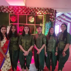 My team of hostesses in elegant traditional green uniforms, ready to welcome and assist guests at a wedding.