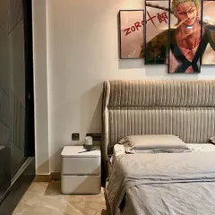 This beige bedroom was designed for a teenager who loves simplicity and anime. The custom "Zoro" artwork above the bed adds a personal touch, reflecting his interests in a stylish way.