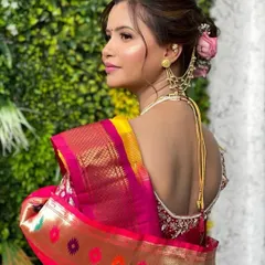 A back view of Siddhi's traditional Maharashtrian bridal hairstyle. The classic bun is adorned with beautiful accessories, completing her regal look.