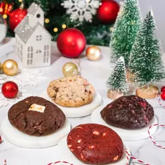 An assortment of gourmet Christmas cookies, styled with festive decorations. This shot is perfect for showcasing a brand's holiday cookie collection.