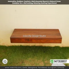 A close-up of a floating wooden bench I designed and installed. This custom hardscaping feature provides minimalist seating and adds a warm, natural element to the garden wall.