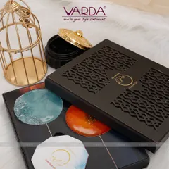 This modern corporate invitation features a laser-cut patterned box that opens to reveal custom-designed coasters. It demonstrates how an invitation can double as a sophisticated corporate gift, leaving a lasting impression on your guests long after the event.