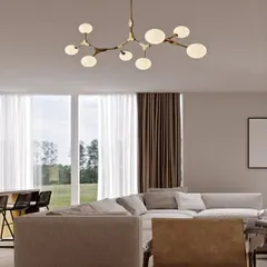 A stunning cluster chandelier featuring nine globular lights branching off a central metallic rod. The antique golden finish and milky white glass create a sophisticated, tree-like structure that is perfect for high-ceiling living rooms.