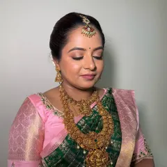A close-up of a classic South Indian bridal makeup look. I used soft pink and gold tones on the eyes to match her saree, paired with a flawless base that looks like second skin.
