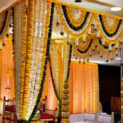 This is a traditional vidhi mandap for a wedding, made with yellow and white marigold garlands. The design is clean and timeless, perfect for sacred Hindu wedding rituals.