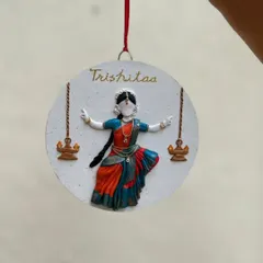 A custom wall decor piece created as a birthday gift for a Bharatanatyam dancer. Her name, "Trishitaa," is written above the hand-sculpted figurine.