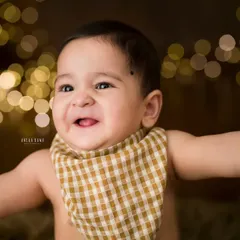 That pure, uncontainable joy. This is the kind of smile that lights up a room, and it's my absolute favorite thing to capture during a milestone baby photography session. A close-up portrait like this freezes a moment of pure happiness.