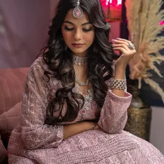 A graceful, introspective pose from a traditional wear photoshoot. This shot captures a quiet moment, showcasing the elegance of the outfit and the model's serene expression.