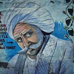A beautiful wall painting of a Rajasthani man with a traditional turban and a grand mustache, captured while exploring the streets of Jodhpur.