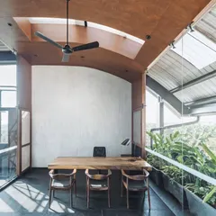 We call this project the 'Terrace Office' for its stunning panoramic views and connection to the outdoors. The director's cabin is a glass box with a vaulted wooden ceiling and its own skylight, offering a sense of openness and an abundance of natural light.