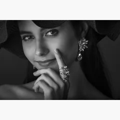 A classic black and white glamour portrait, highlighting fine jewelry and a captivating expression. This style is perfect for models, actors, and professionals in the beauty and fashion industries seeking a sophisticated portfolio piece.