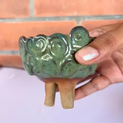 A student holding her beautifully glazed, three-legged pinch pot. I love seeing the pride and joy in my students' faces when they see their finished work.