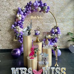 A beautiful lavender-themed "Miss to Mrs" party setup. We used shades of purple and silver for the balloon decor, with elegant pedestals for the cake and treats, creating a sophisticated look.