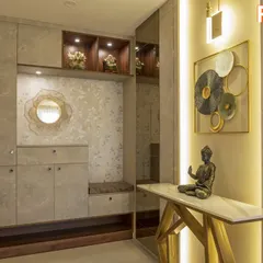 This foyer from our Vaswani Menlo Park project welcomes you with earthy tones, a custom storage unit with a seating nook, and a console table highlighted by warm backlighting.