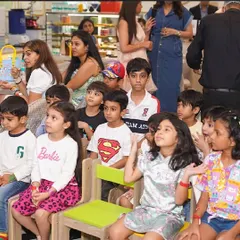 Children and adults sit together, captivated by the entertainment. Our parties are designed for everyone to enjoy.