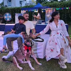 A happy family enjoying the event from the sidelines. We ensure there's comfortable seating and a relaxed atmosphere for everyone, making it a great day out for the entire family, not just the pets.
