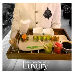 Where every bite defines luxury. A server presents a tray of beautifully plated sushi, emphasizing our focus on creating a high-end dining experience through both taste and presentation.