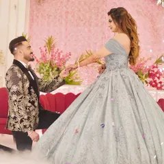 A magical moment captured as the groom proposes to his bride, who is wearing my ethereal light blue ball gown. The voluminous skirt creates a beautiful silhouette, perfect for romantic photos.