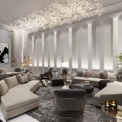 In this expansive living area for a private villa, we used classical archways and a celestial lighting installation to define a grand, yet intimate, seating arrangement. The design fosters a sense of community within a luxurious setting.
