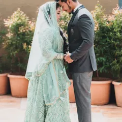 An intimate and serene portrait of a couple on their wedding day, holding hands and sharing a quiet moment together.
