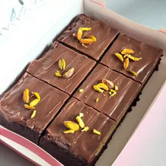 Here's a look inside a box of my special Kunafa Brownie Bars. I layer my best-selling fudgy brownies with a crunchy pistachio kunafa filling and top it all with smooth milk chocolate for a perfect blend of textures.