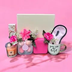 This pretty-in-pink hamper is all about self-care. It features a scented candle, beauty blenders, a "You are the best" mug, a silk eye mask, and other pampering goodies.