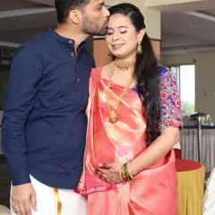 A sweet, candid moment. The makeup is subtle yet elegant, designed to photograph beautifully and last through all the happy moments of the baby shower.