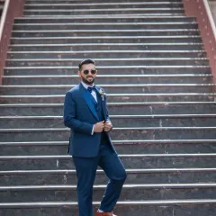 Using the strong leading lines of the staircase to create a dynamic and stylish portrait of the groom.