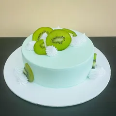 A vibrant and refreshing Kiwi Cake. The light green frosting and fresh kiwi slices make it a light and fruity dessert option.
