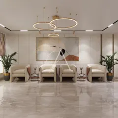 A waiting area designed for comfort and style. The clean lines of the contemporary armchairs and the abstract art create a calm and professional atmosphere for visitors, complemented by soft, layered lighting from modern ring chandeliers.