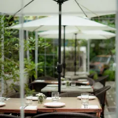 Our outdoor seating area, lined with umbrellas, offers a lovely spot to enjoy a meal al fresco. It's a little oasis of calm in the city.