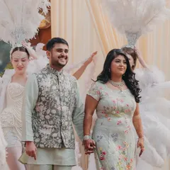The couple making their grand entrance, hand in hand. This shot captures the excitement and pride of their first appearance as a soon-to-be-married couple.