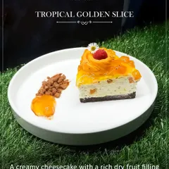 A tropical golden slice of creamy mango cheesecake with a rich dry fruit filling and a sun-ripened mango glaze. This dessert is a true celebration of the season's sweetest treasure.