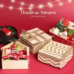 My Christmas hamper collection features a variety of unique packaging, including house-shaped boxes, woven baskets, and elegant black boxes with festive lights.