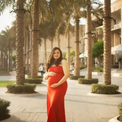 For this shot, we swapped the dramatic tulle gown for a sleek, bodycon red dress. It shows how a simple change of outfit can create a completely different, more modern vibe in the same beautiful outdoor location.