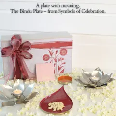 The Bindu plate, from our 'Symbols of Celebration' collection, is designed with meaning. Here it is shown as part of a complete gift set, with lotus diyas and a beautiful floral box, perfect for festive gifting.