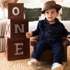 A dapper pre-birthday portrait in my studio, using classic props like 'ONE' blocks to create a timeless memory of this milestone.