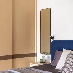 The bedroom features a sliding wardrobe in a light wood finish, with a contrasting dark band. The simple, clean lines are a hallmark of the Wabi-Sabi aesthetic.