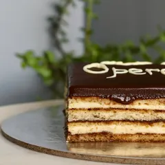 A close-up of the beautiful layers in my Opera Cake. You can see the perfect harmony of coffee, chocolate, and almond sponge, making it a true showstopper.