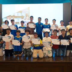 The U13 and U15 players from our Xcelerate program pose for a group photo on stage with their certificates. This is a moment to recognize the progress and dedication of our youth teams.