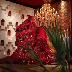 We transformed this space with a colossal installation inspired by a traditional Indian Baoli (stepwell). Towering at 450 centimeters and crafted from over 10,000 red Sola flower pieces, it creates a powerful, sculptural statement.