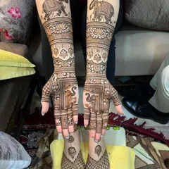 A complete bridal set with matching designs for hands and feet. The arms feature majestic elephants, while the feet have a simpler, elegant pattern.