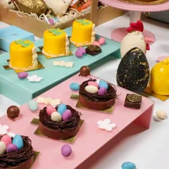 Our Easter dessert table features an assortment of beautifully crafted sweets. From mini chocolate nests filled with candy eggs to small lemon cakes, every item is designed to fit the festive theme.